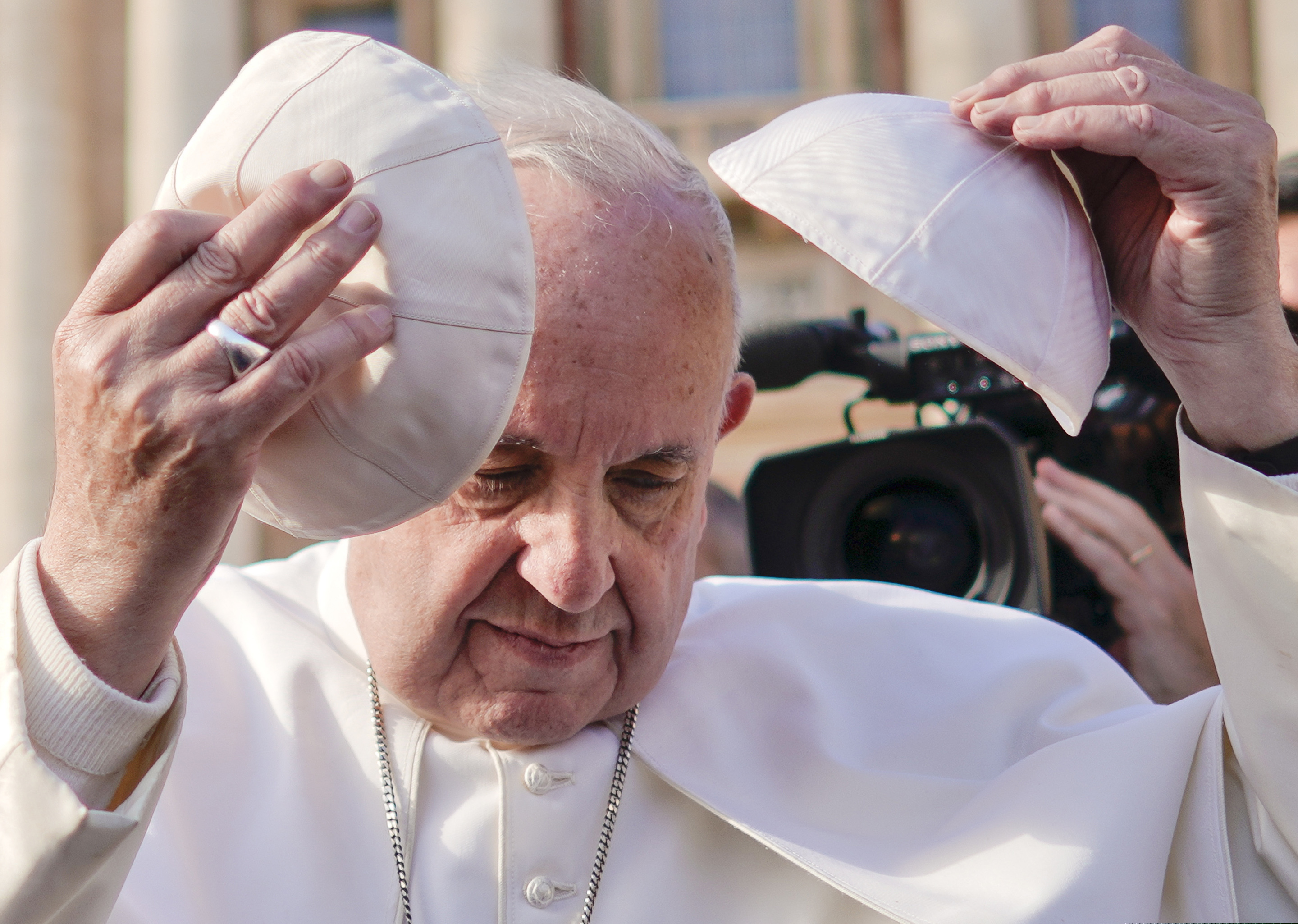 (AP Photo/Andrew Medichini) Pope Francis tries on a cap he was offered as he leaves at the end of his weekly general audience, in St. Peter's Square, at the Vatican, Wednesday, Nov. 21, 2018.