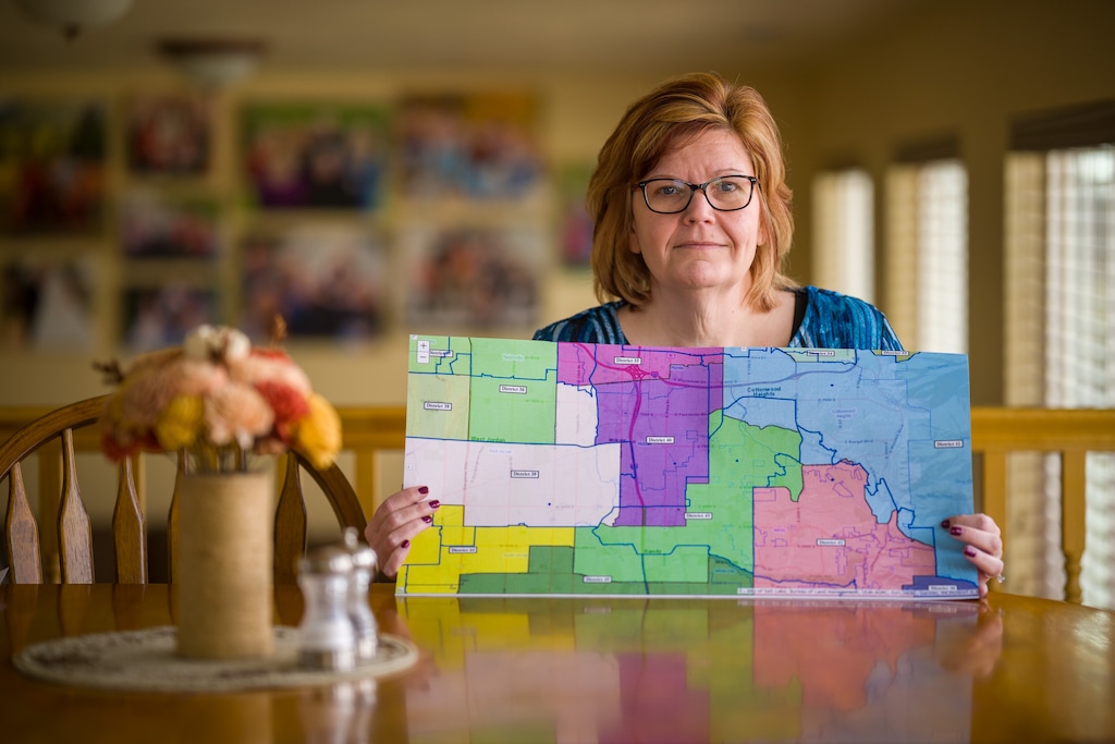 (Trent Nelson | The Salt Lake Tribune) Wendy Davis, a Democrat who narrowly lost a state House seat in 2020, at her home in Sandy on Thursday, Nov. 18, 2021. Davis said she's been cut out of her former opponent's district, Republican Rep. Steve Eliason. She's holding a map that shows, in color, the new districts, with the previous districts outlined.