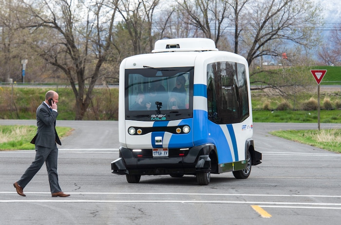 (Rick Egan  |  The Salt Lake Tribune)   Lt. Governor Spencer J. Cox walks in front of an Autonomous Shuttle, to see if it will stop for him, during a demonstration as the Utah Department of Transportation, in partnership with the Utah Transit Authority, launched a new Autonomous Shuttle Pilot Project at the test track is across the street from UDOT headquarters on the west side of 2700 West. Thursday, April 11, 2019.


