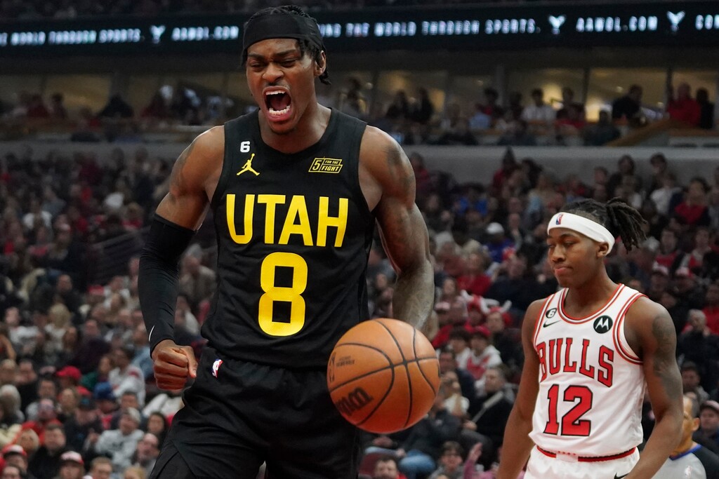 Utah Jazz forward Jarred Vanderbilt (8) reacts after scoring as Chicago Bulls guard Ayo Dosunmu (12) stands nearby during the second half of an NBA basketball game Saturday, Jan. 7, 2023, in Chicago. (AP Photo/David Banks)