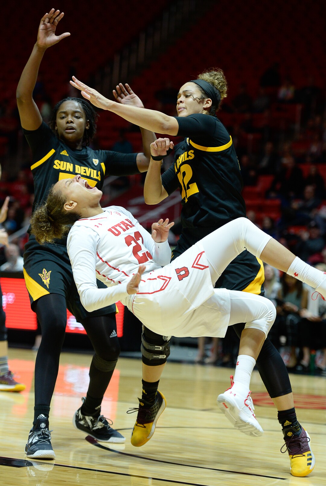 (Francisco Kjolseth  |  The Salt Lake Tribune)  Utah Utes guard/forward Daneesha Provo (23) takes a hard hit that injures her knee while battling ASU in Utes' Pac-12 home opener at the Jon M Huntsman Center on Friday, Jan. 4, 2019. Off to one of their best starts in team history, their twelve in a row winning streak came to an end losing to the Sun Devils 63-65.