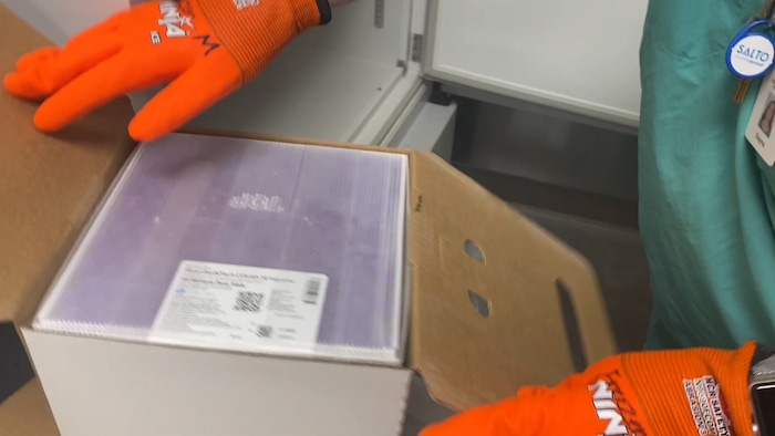 (Photos courtesy Intermountain Healthcare) An employee at Utah Valley Hospital in Provo unboxes the state of Utah's first batch of COVID-19 vaccine, on Monday, Dec. 14, 2020. The vaccine, developed by Pfizer Inc. and BioNTech, must be stored at around 95 degrees below zero Fahrenheit, so it is shipped surrounded by dry ice and stored in a supercold freezer.