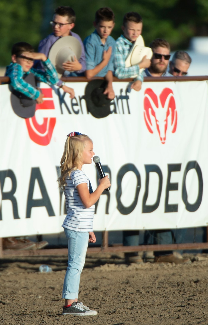 (Rick Egan  |  The Salt Lake Tribune)    Seven-year-old Clara Robbins sings the National Anthem, at the West Jordan Western Stampede Rodeo, Saturday, July 6, 2019.