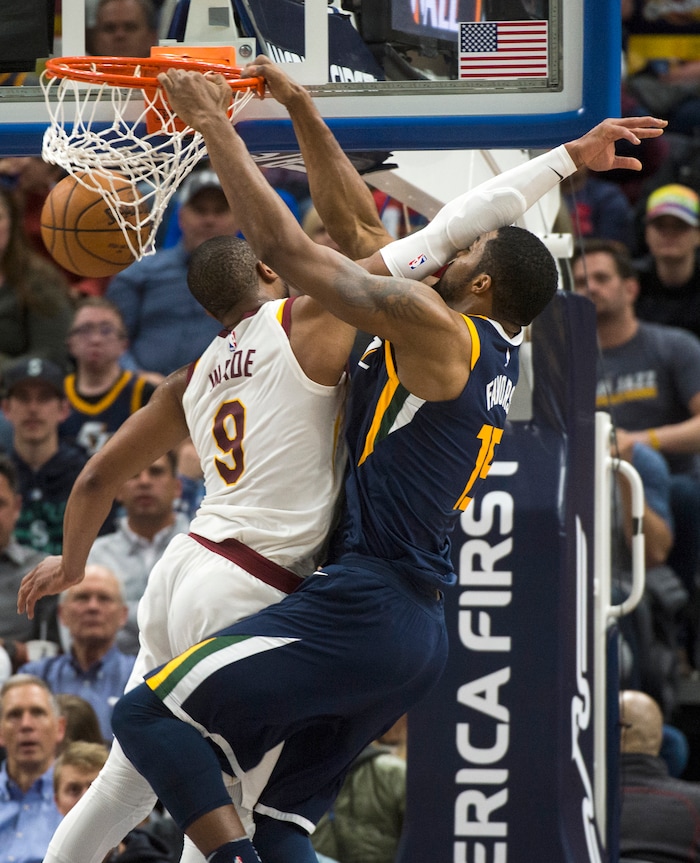 (Rick Egan  |  The Salt Lake Tribune)   Utah Jazz forward Derrick Favors (15) scores as he is fouled by Cleveland Cavaliers guard Dwyane Wade (9), in NBA action Utah Jazz vs Cleveland Cavaliers, in Salt Lake City,  Saturday, December 30, 2017.


