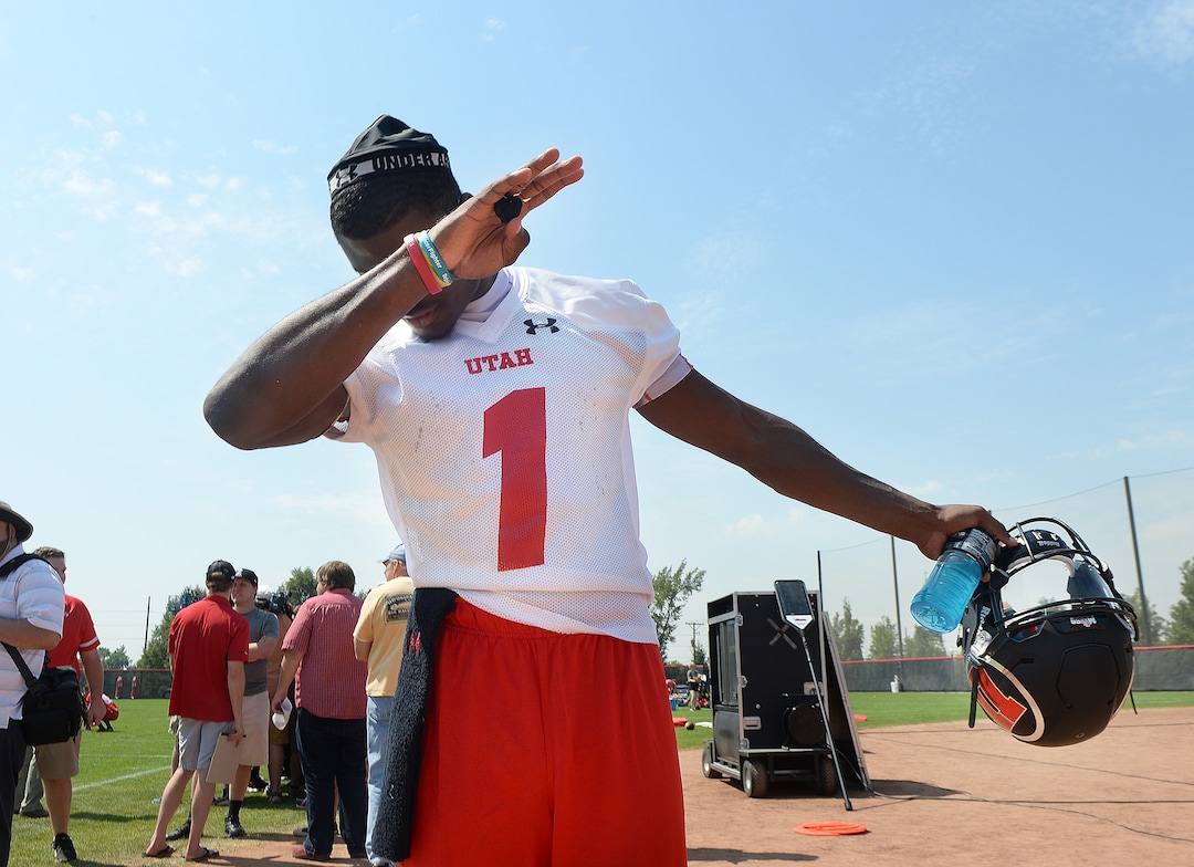 Scott Sommerdorf   |  The Salt Lake Tribune  Utah QB Tyler Huntley playfully dabs after coming off the practice field, Thursday, August 4, 2016.