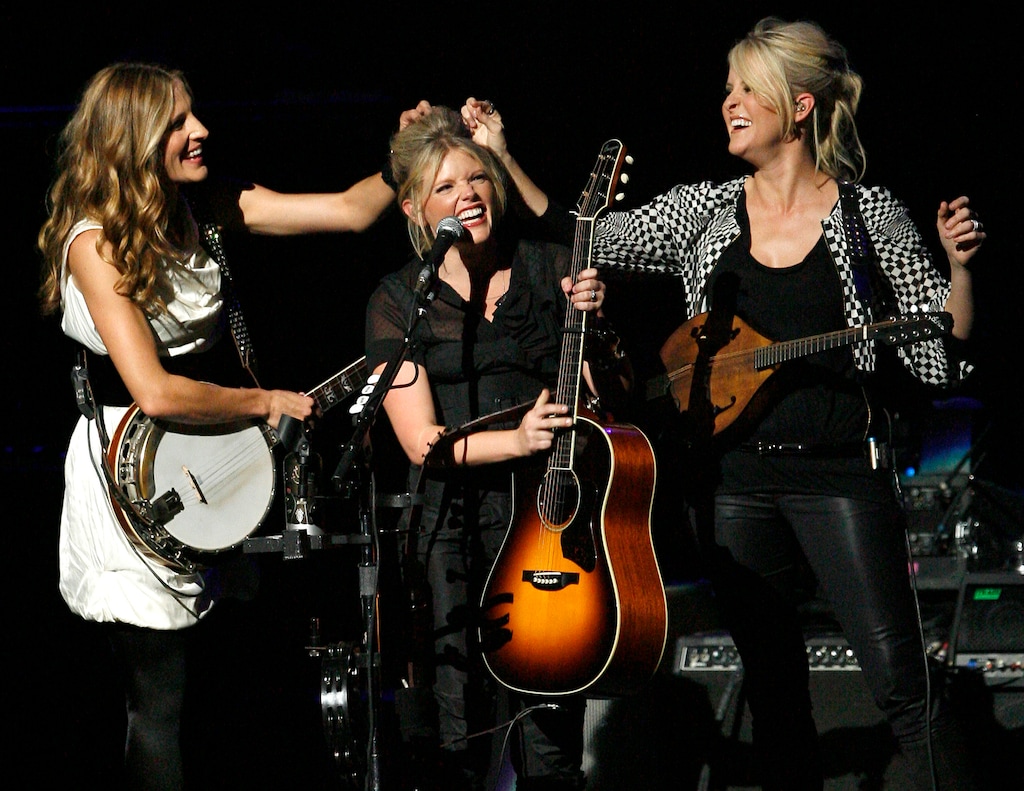 (Gus Ruelas | AP file photo)
In this Oct. 18, 2007, photo, Emily Robison, left, and Martie Maguire, right, adjust Natalie Maines' hair as the Dixie Chicks perform at the new Nokia Theatre in Los Angeles. The Grammy-winning country group have dropped the word dixie from their name and are now going by The Chicks. The move follows a decision by country group Lady Antebellum to change to Lady A after acknowledging the word's association to slavery.