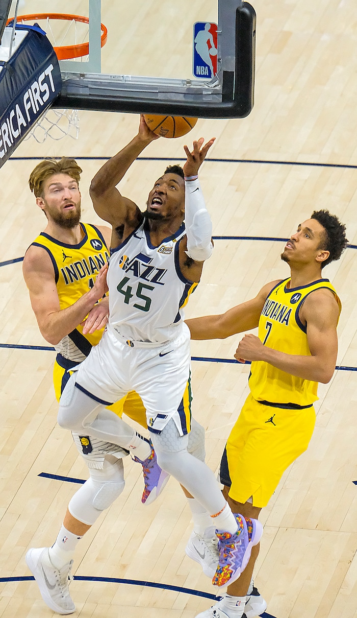 (Leah Hogsten | The Salt Lake Tribune) Utah Jazz guard Donovan Mitchell (45) goes past Indiana Pacers forward Domantas Sabonis (11) and Indiana Pacers guard Malcolm Brogdon (7) as the Jazz host the Pacers, Friday, April 16, 2021, at Vivint Arena.