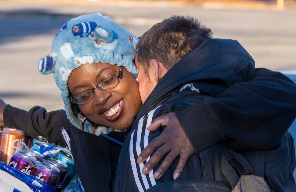 (Rick Egan | The Salt Lake Tribune)Ty Bellamy hugs an old friend as she distributes "Gratitude Dinners" to one of the camps, as volunteers from the group Black Lives for Humanity, on 500 West in Salt Lake City, on Thursday, Nov. 25, 2021. The group served   to more than 100 people from the unsheltered population, with donations from the community, and many more had food delivered to them by volunteers at camps around the city.