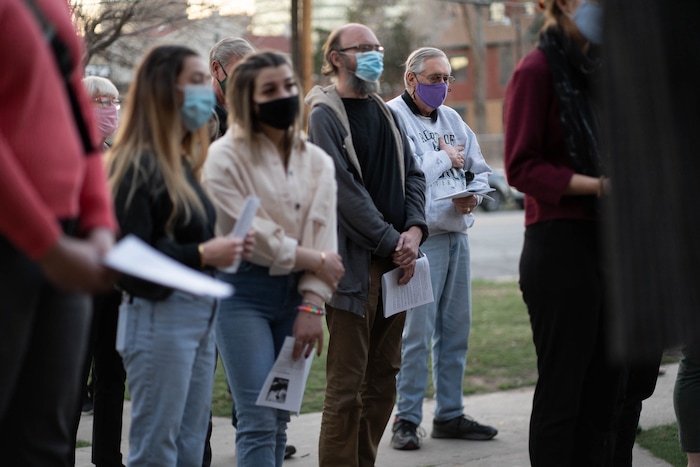 (Francisco Kjolseth | The Salt Lake Tribune) Mask wearing Utah Christians make a stop at Crossroads Food Pantry as part of their walk through Salt Lake City beginning at Cathedral of the Madeleine on Good Friday, to symbolically mark Jesus' carrying the cross to his crucifixion, April 2, 2021.