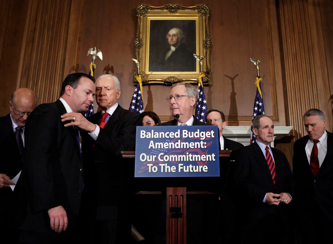 (J. Scott Applewhite | AP) Senate Republican leader Mitch McConnell of Kentucky gathers other Republican senators to call for an amendment to the Constitution requiring a balanced federal budget, at the Capitol in Washington, Thursday, March 31, 2011. To the left is Sen. Orrin Hatch conferring with then-freshman Sen. Mike Lee.