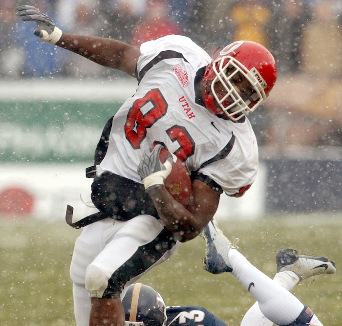 (Rick Egan  |  Tribune file photo)  Ute Paris Warren is tripped up by BYU's O'Neal Howell, in the Utes 3-0 win over the cougars on Saturday November 22, 2003 at LaVell Edwards Stadium.