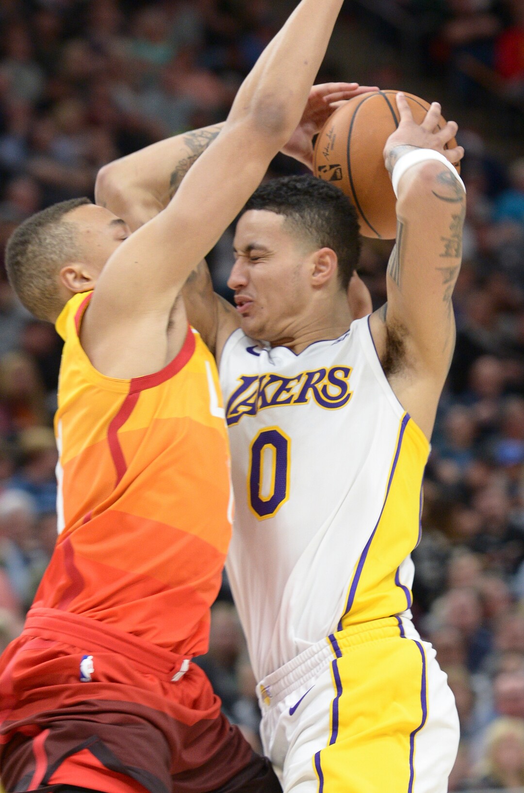 (Leah Hogsten  |  The Salt Lake Tribune)   Los Angeles Lakers forward Kyle Kuzma (0) and Utah Jazz guard Dante Exum (11) collide.The Utah Jazz defeated the Los Angeles Lakers 117-110 at Vivint Smart Home Arena Tuesday, April 3, 2018