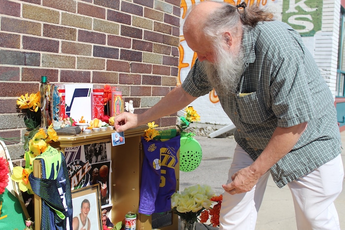 (Christopher Kamrani | The Salt Lake Tribune) Ken Sanders of Ken Sanders Rare Books adds a photo found by one of his employees in a book Monday inside his store to the Utah Jazz playoff shrine on the corner of 200 East and 300 South in downtown Salt Lake City on Monday, April 23, 2018.