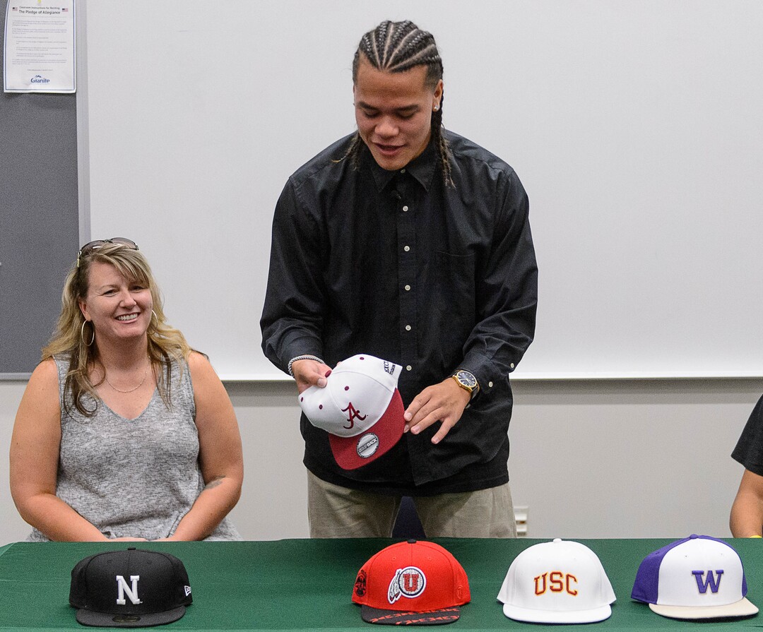 (Trent Nelson  |  The Salt Lake Tribune)  Olympus tight end Cameron Latu announces he's headed to Alabama during a news conference at Olympus High School in Salt Lake City Friday August 4, 2017. His mother Jill Argust is at left.