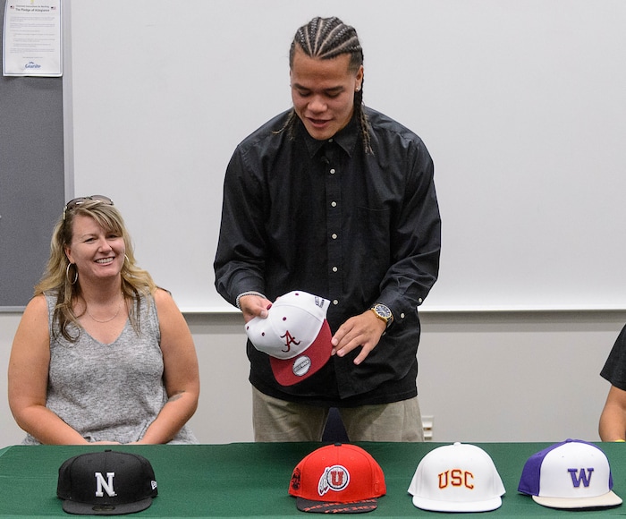 (Trent Nelson  |  The Salt Lake Tribune)  Olympus tight end Cameron Latu announces he's headed to Alabama during a news conference at Olympus High School in Salt Lake City Friday August 4, 2017. His mother Jill Argust is at left.