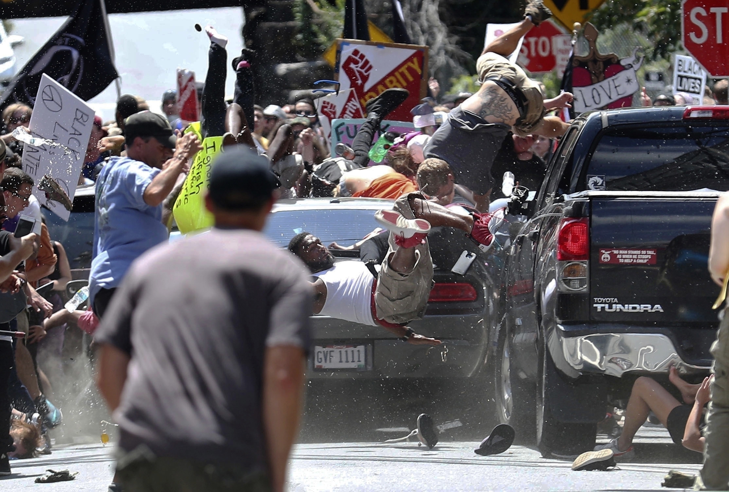 (Ryan M. Kelly | The Daily Progress via AP file photo)  In this Aug. 12, 2017, photo, people fly into the air as a vehicle is driven into a group of protesters demonstrating against a white nationalist rally in Charlottesville, Va. James Alex Fields Jr. was sentenced to to life in prison on federal hate crime charges for deliberately driving his car into anti-racism protesters during a white nationalist rally in Virginia.