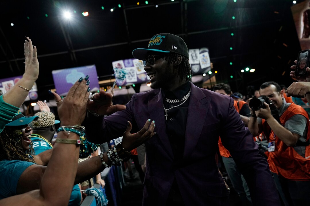 Utah linebacker Devin Lloyd celebrates with supporters after being chosen by the Jacksonville Jaguars with the 27th pick of the NFL football draft Thursday, April 28, 2022, in Las Vegas. (AP Photo/Jae C. Hong)