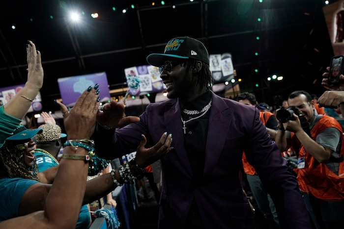 Utah linebacker Devin Lloyd celebrates with supporters after being chosen by the Jacksonville Jaguars with the 27th pick of the NFL football draft Thursday, April 28, 2022, in Las Vegas. (AP Photo/Jae C. Hong)