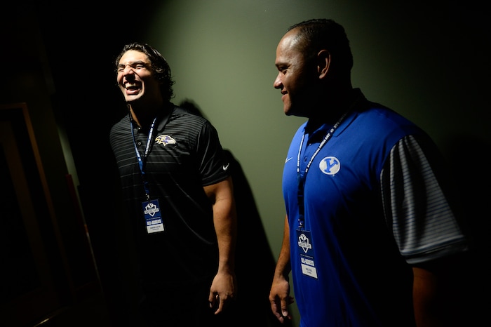 (Francisco Kjolseth  |  The Salt Lake Tribune)  " I was up next till I got bumped by the big man," exclaims Vince Feula, right, defensive graduate assistant as he teases Bronson Kaufusi with the Baltimore Ravens, left, and former BYU football players as they wait to do recruiting interviews during football media day at the BYU-Broadcasting Building on Friday, June 22, 2018.