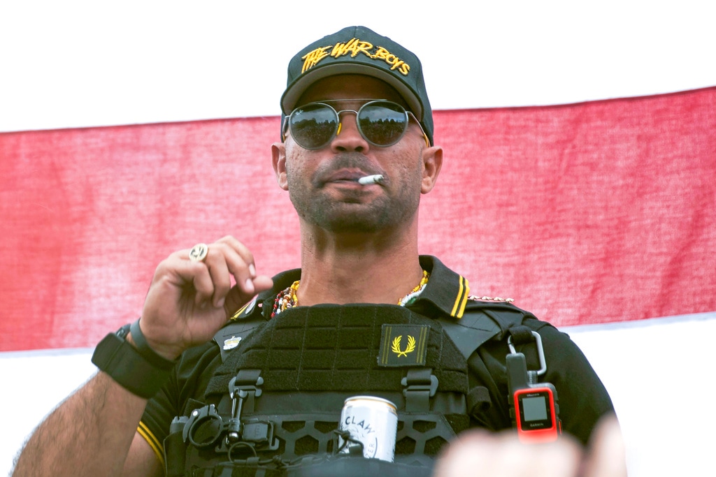 (Allison Dinner | AP file photo) Proud Boys leader Henry "Enrique" Tarrio wears a hat that says The War Boys during a rally in Portland, Ore., Sept. 26, 2020. A federal jury is set to hear closing arguments in the historic trial of Proud Boys extremist group leaders charged with plotting to use force to keep former President Donald Trump in power. Starting Monday, April 24, 2023, prosecutors and defense lawyers will make their final appeals to jurors who will decide the fate of former Proud Boys national chairman Enrique Tarrio and four lieutenants.