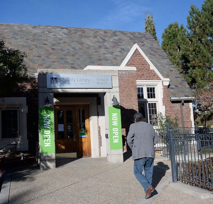 (Al Hartmann | The Salt Lake Tribune)
People trickle in to the Sprague Library Monday morning Oct. 23 with limited service after its basement flooded in July, causing a loss of thousands of books. The main floor of the English Tudor style building is open and rearranged. The basement which housed non-fiction, children's books, and community meeting rooms will remain closed for some time.