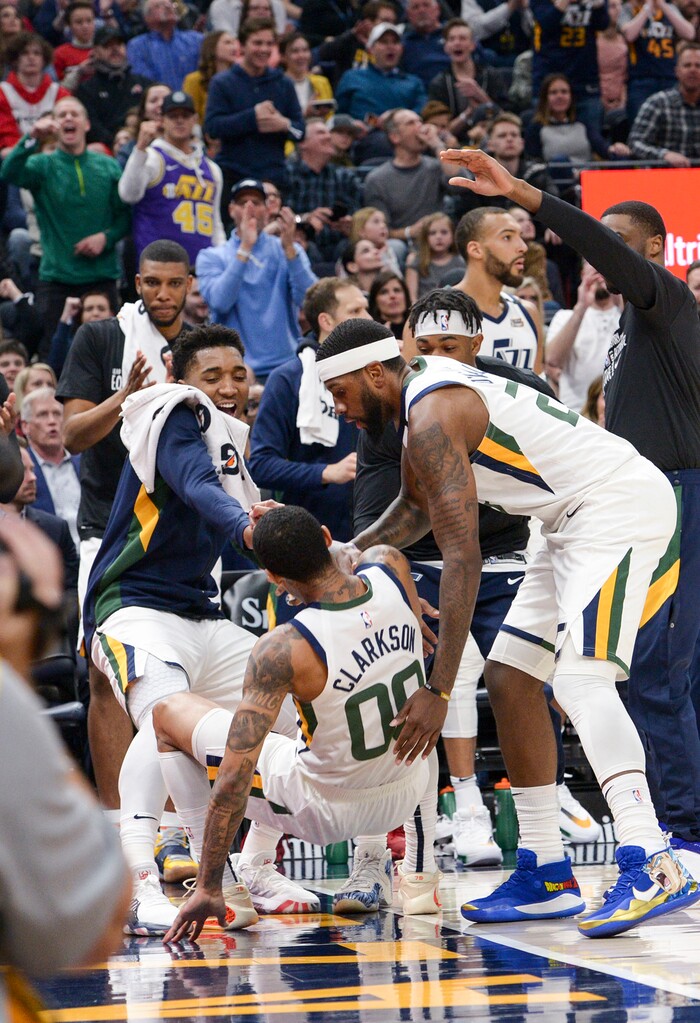 (Leah Hogsten  |  The Salt Lake Tribune) Utah Jazz guard Jordan Clarkson (00) is helped to his feet by Utah Jazz guard Donovan Mitchell (45) and Utah Jazz forward Royce O'Neale (23) after hitting the deck.  The Utah Jazz host the Houston Rockets at Vivint Arena, Feb. 22, 2020.