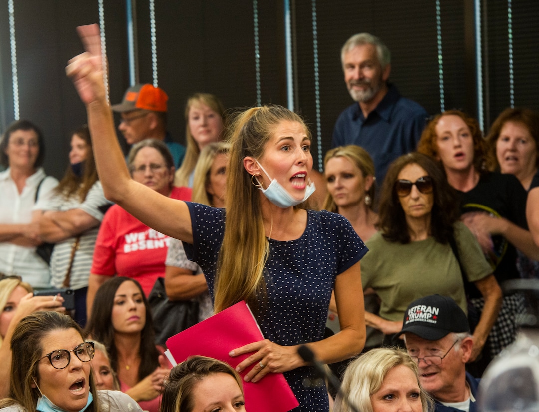 (Rick Egan  |  The Salt Lake Tribune)    Angry residents react when the Utah County Commission meeting was adjourned before it even started. The group protesting against masks being required in schools removed the social distancing tape on the chairs and filled the Utah County Commission room to over flowing, prompting Commissioner Tanner Ainge to call for a vote to adjourn the meeting in Provo, on Wednesday, July 15, 2020.