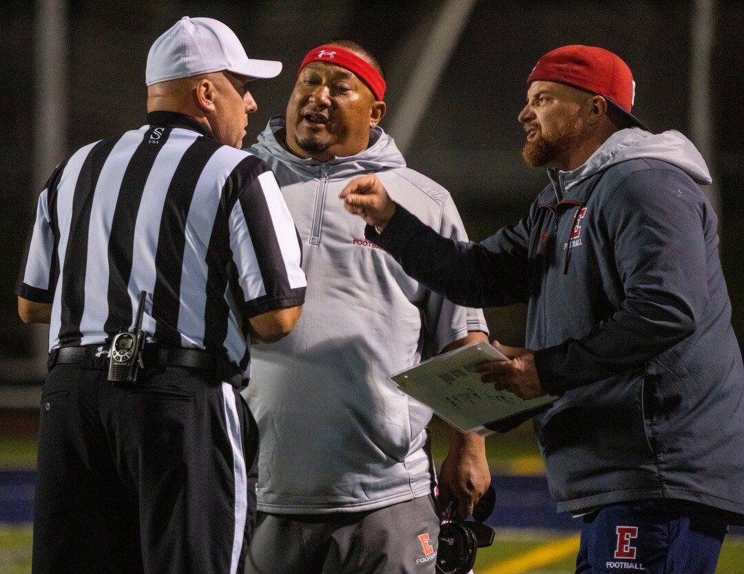 (Rick Egan | The Salt Lake Tribune) East High coaches talk to the official, after the their quarterback Siona Vailahi (4) was knocked out of the gamed, after a hard hit, in prep football action between Corner Canyon Chargers and the East Leopards, on Saturday, Aug. 21, 2021.