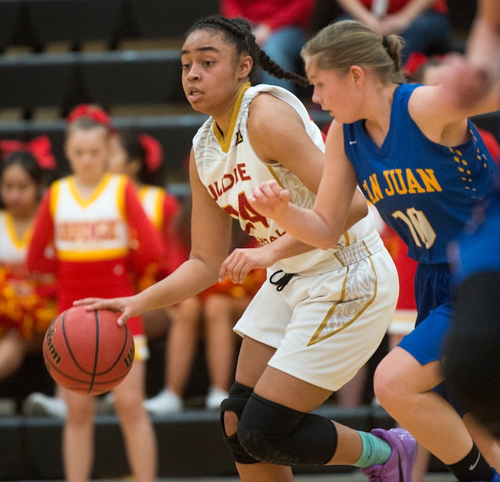 (Rick Egan  |  The Salt Lake Tribune)   Judge Memorial guard Miyalla Tarver (24), brings the ball down court, as Brittany Grover, 10, defends for San Juan, in 3A Women's basketball State playoff action Judge Memorial Vs. San Juan, in Heber City, Friday, Feb. 16, 2018.