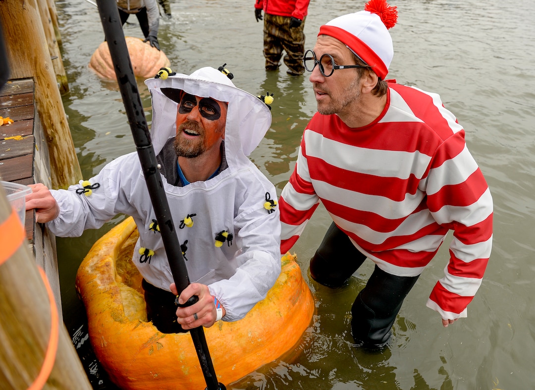 (Leah Hogsten  |  The Salt Lake Tribune) l-r Clint Urry is helped into his pumpkin boat with the help of Robb Baumann during the annual Giant Pumpkin Regatta, October 19, 2019 on Oquirrh Lake in Daybreak, South Jordan.