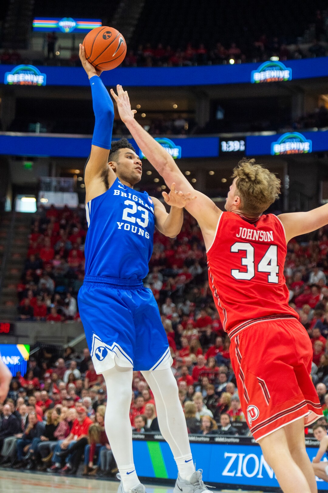 (Rick Egan  |  The Salt Lake Tribune)   Brigham Young Cougars forward Yoeli Childs (23) shoots overUtah Utes center Jayce Johnson (34), in basketball action in the Beehive Classic, between against the Brigham Young Cougars and Utah Utes, at the Vivint Smart Home Arena, Saturday December 8, 2018.