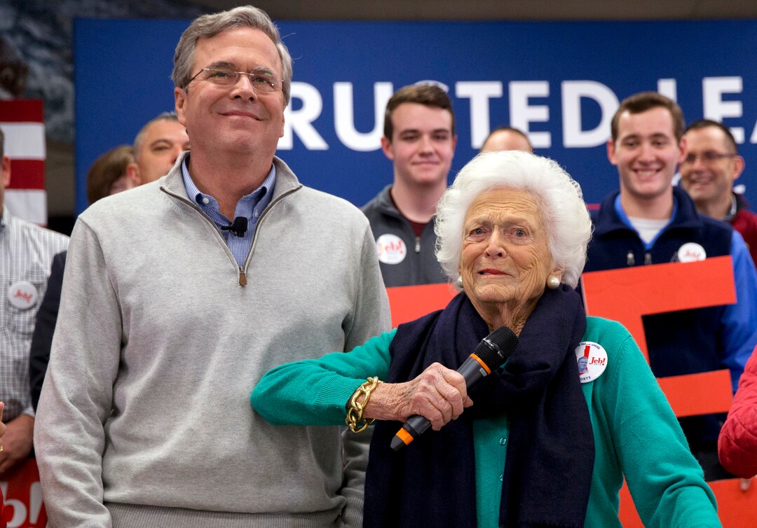 FILE - In this Feb. 4, 2016, file photo, Barbara Bush, right, jokes with her son Republican presidential candidate, former Florida Gov. Jeb Bush, while introducing him at a town hall meeting at West Running Brook Middle School in Derry, N.H. A family spokesman said Tuesday, April 17, 2018, that former first lady Barbara Bush has died at the age of 92. (AP Photo/Jacquelyn Martin, File )