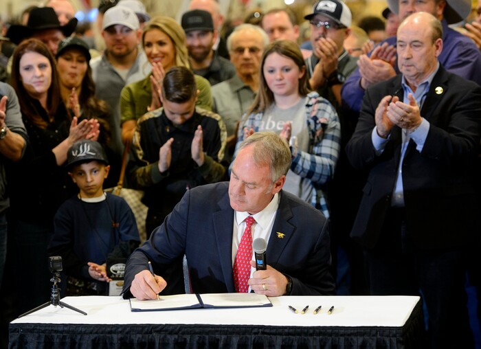 (Steve Griffin  |  The Salt Lake Tribune)  U.S. Secretary of the Interior Ryan Zinke, in an appearance at the Western Hunting and Conservation Expo at the Salt Palace Convention Center in Salt Lake City, signs Secretarial Order 3362, aimed at improving habitat quality and Western winter range and migration corridors for big game.