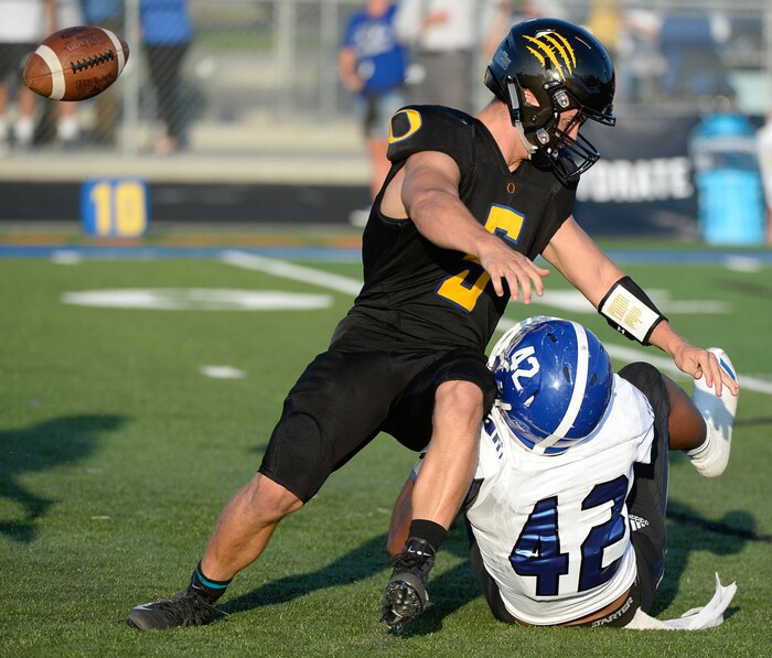 (Francisco Kjolseth  |  The Salt Lake Tribune)  Orem's quarterback Cooper Legas is taken down by Bingham's Sione Fotu in the first half of the game Thursday, Aug. 16, 2018 in Orem.