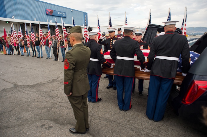 (Rick Egan  |  The Salt Lake Tribune)      The remains of Marine Pfc. Robert K. Holmes are carried from the Delta Air Cargo to a hearse for transportation to the mortuary.  Holmes died aboard the USS Oklahoma during the attack on Pearl Harbor. Friday, Aug. 17, 2018.
