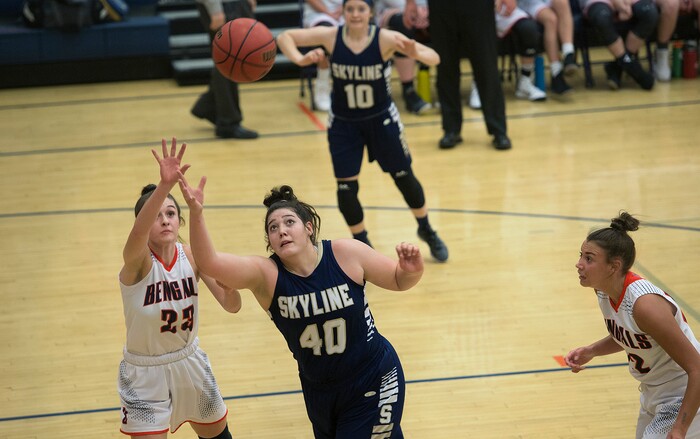 (Scott Sommerdorf   |  The Salt Lake Tribune)   Skyline's Cameron Mooney and Brighton's Sidney Kaufman reach for an errant pass during first half play. Skyline defeated Brighton 66-33, Friday, January 5, 2018.