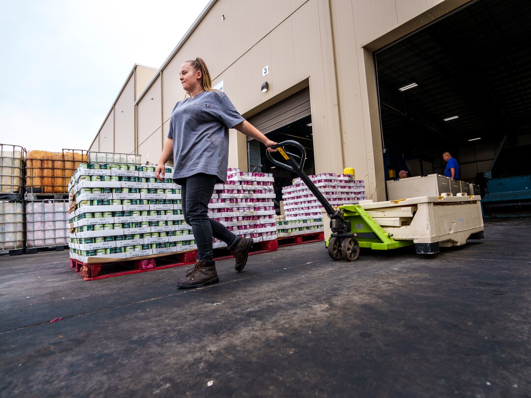 (Leah Hogsten | The Salt Lake Tribune) Wasatch Resource Recovery employee McKala Tippetts wheels an empty bin, once filled with ice cream sandwiches for processing, Sept. 1, 2021. Wasatch Resource Recovery is UtahÕs first and only anaerobic digester which produces a fertilizer and natural gas from decomposing food. The facility processes organic waste which includes food scraps, liquid waste and manufacturing food waste. The process, in operation since 2019, turns the organic matter into sustainable resources, biogas and bio-based fertilizer and the facility will pilot a food scraps pickup program for residents.