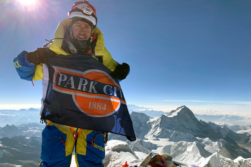 (Caroline Gleich via AP) This May 24, 2019, photo provided by Caroline Gleich shows Rob Lea on the summit of Mount Everest in Nepal. Lea dubbed his trek "The Ultimate World Triathlon" as he climbed Mount Everest through whipping wind, swam in the frigid waters of the English Channel wearing nothing more than a Speedo — enduring constant jellyfish stings as well — and rode his bike, through painful saddle sores, from one American coast to the other.