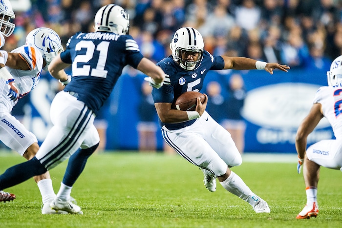 (Chris Detrick  |  The Salt Lake Tribune)  Brigham Young Cougars running back Ula Tolutau (5) runs the ball past Boise State Broncos cornerback Avery Williams (26) during the game LaVell Edwards Stadium Friday, October 6, 2017. 