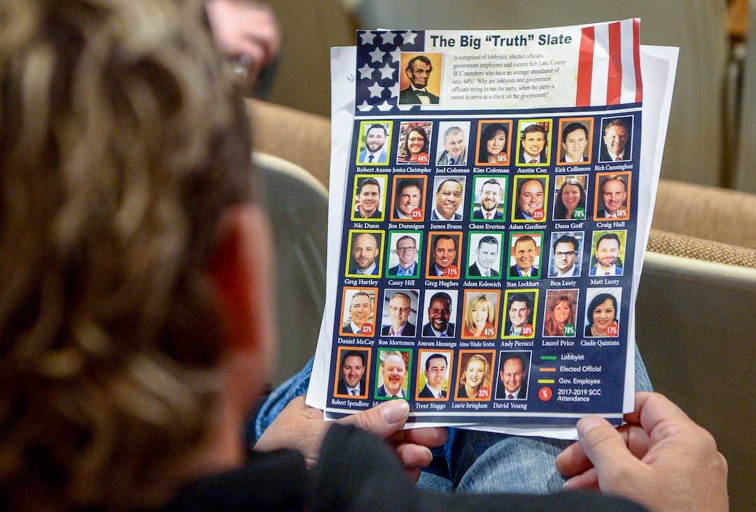 (Leah Hogsten  |  Tribune file photo)  A delegate holds a flyer featuring Republican Central Committee members and their attendance rates at the Salt Lake County Republican Party organizing convention, April 13, 2019, at Cottonwood High School. Salt Lake County GOP leaders are creating a policy on harassment and inviting people with complaints to come forward.
