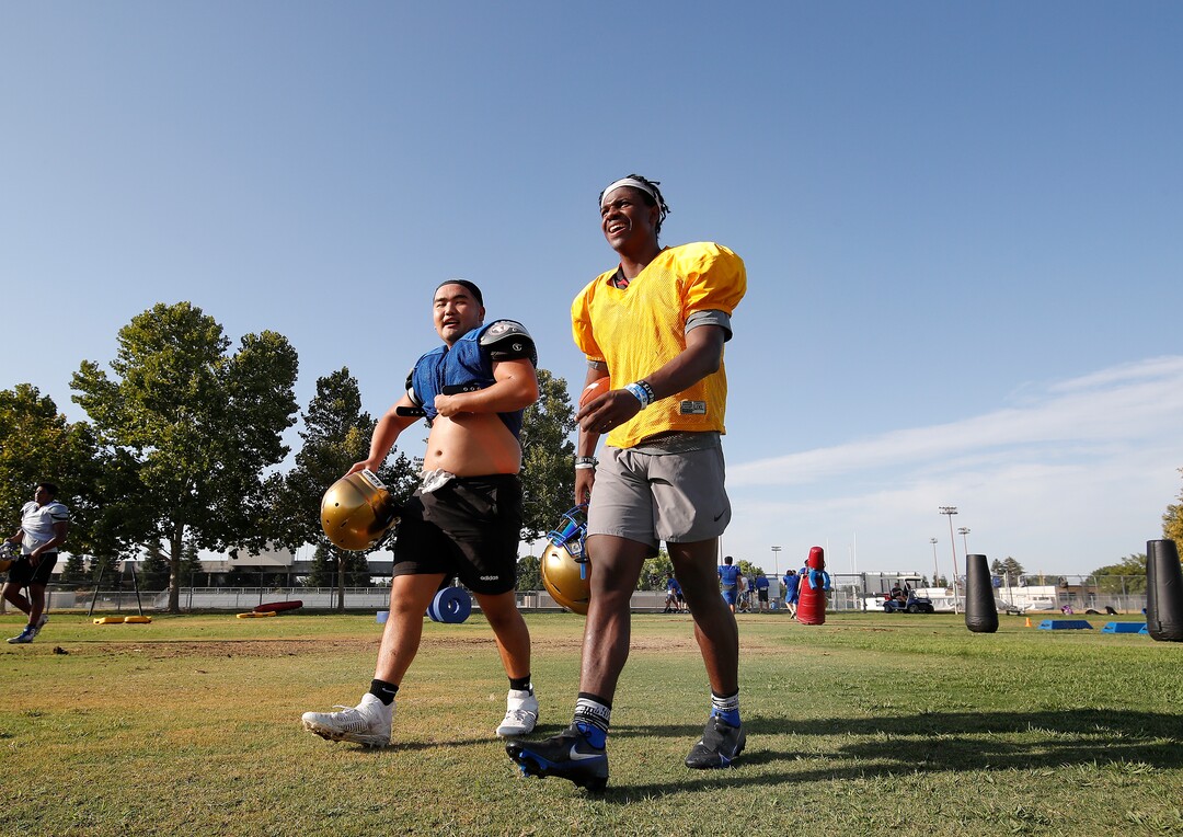 (Gary Kazanjian | Special to The Tribune) Clovis High School quarterback Nate Johnson works out with his team at Clovis High School, who committed to play for the University of Utah, shown Wednesday, July 28, 2021, in Clovis, Calif.