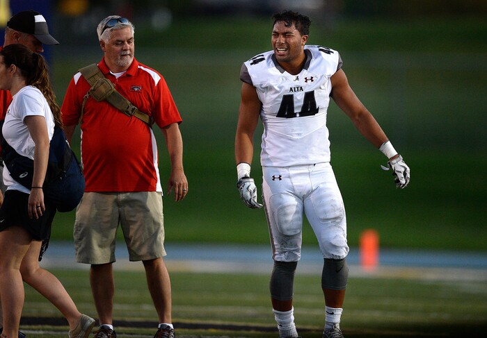 (Scott Sommerdorf | The Salt Lake Tribune)
Alta LB MJ Tafisi grimaces after he was injured during first half play. Alta led Taylorsville 42-12 at the half, Friday, September 1, 2017.