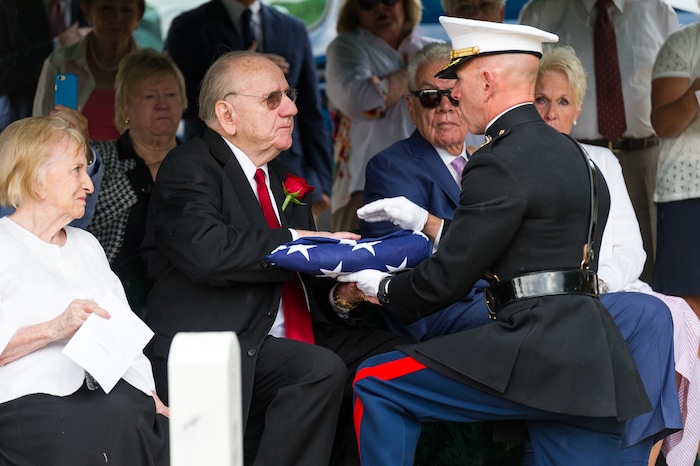 (Alex Gallivan  |  Special to The Tribune) Bob Holmes, the nephew of Marine Pfc. Robert K. Holmes, who died 77 years ago aboard the USS Oklahoma during the attack on Pearl Harbor, receives the flag from the Marine Corp at the Salt Lake City Cemetery, Monday, Aug. 20, 2018.