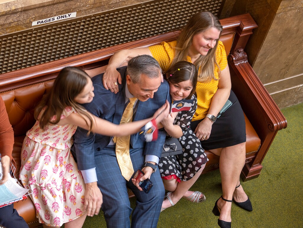 (Leah Hogsten | The Salt Lake Tribune) Sen. Daniel McCay, R-Riverton and his family celebrate passage of SB31, the bill to change Utah’s state flag on the House floor at the Capitol, Mar. 2, 2023. SB31 adopts the redesigned flag as the official flag of Utah and gives three iterations of the current flag “historical” designation.