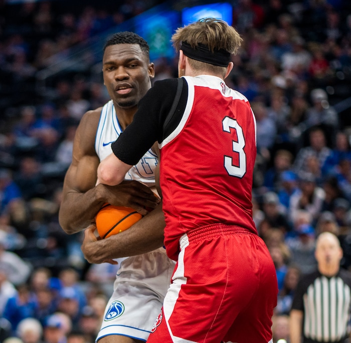 (Rick Egan | The Salt Lake Tribune)  South Dakota Coyotes guard Max Burchill (3) ants on to the ball after the whistle along with Brigham Young Cougars forward Atiki Ally Atiki (4), in basketball action between the Brigham Young Cougars and the South Dakota Coyotes, at Vivint Arena, in Salt Lake City, on Saturday, Dec. 3, 2022.
