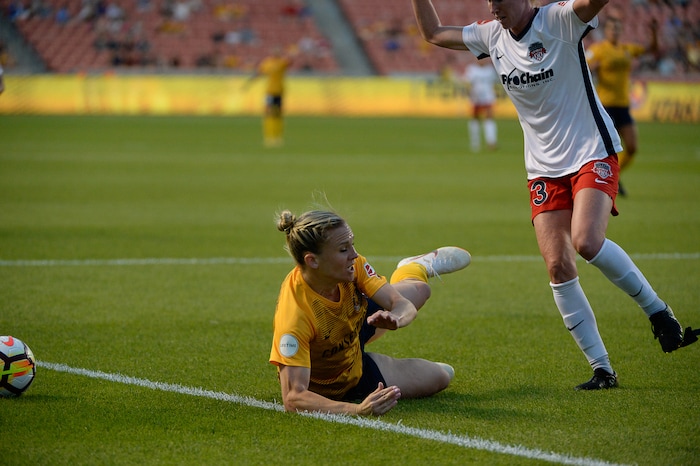 (Francisco Kjolseth  |  The Salt Lake Tribune)  Utah Royals FC hosts Washington Spirit, NWSL soccer at Rio Tinto Stadium in Sandy, Wed. Aug. 8, 2018. Utah Royals FC forward Amy Rodriguez (8) takes a tumble while defended by Washington Spirit midfielder Tori Huster (23), losing part of her shoe, during the first half of the game. 