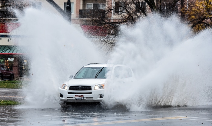 (Francisco Kjolseth  |  The Salt Lake Tribune)  Street corners in downtown Salt Lake are filled with standing water due to clogged storm drains during the rain storm on Friday, Nov. 17, 2017. 