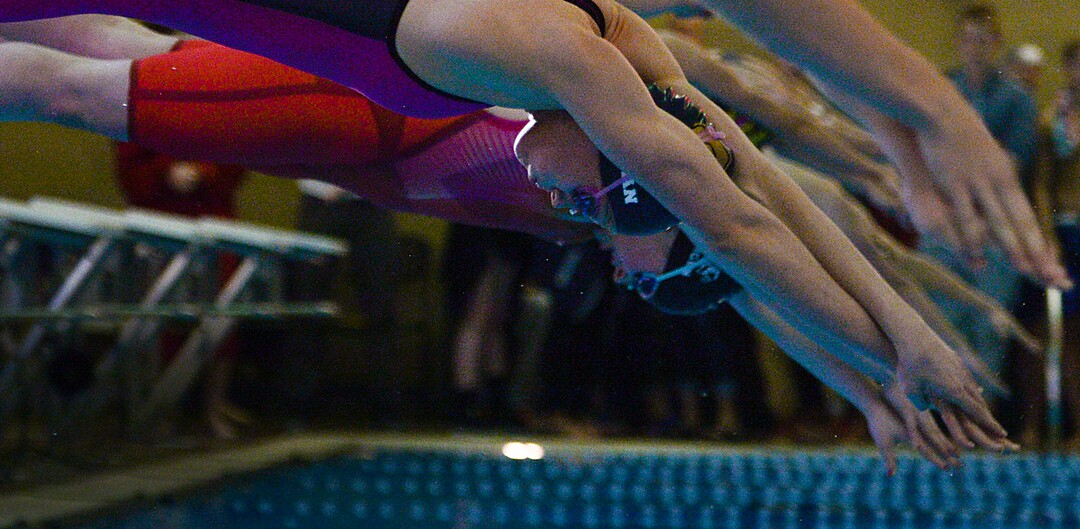 (Leah Hogsten  |  The Salt Lake Tribune) Competitors in the 100 yard breaststroke leap off the blocks at the Class 5A State Championships in Bountiful, Saturday, February 10, 2018. 