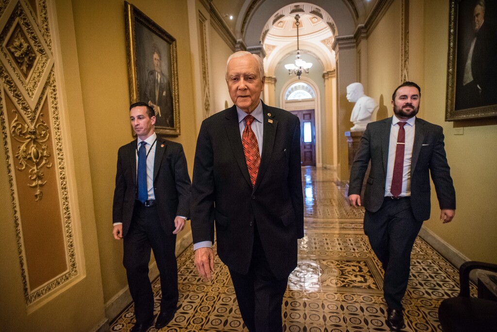(Andr Chung  |  special to The Salt Lake Tribune) Flanked by his security staff on the left and Matt Whitlock, his communications director on the right, Sen. Hatch makes his way to a luncheon in Washington D.C. on December 21, 2017. Senator Orrin Hatch is the senior senator from Utah, Chairman of the Senate Finance Committee and President pro tempore of the United States Senate.