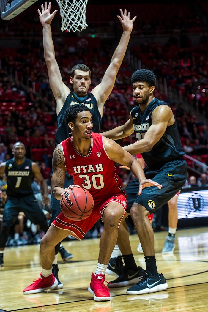 (Chris Detrick  |  The Salt Lake Tribune)  Missouri Tigers forward Reed Nikko (14) and Missouri Tigers forward Jordan Barnett (21) guards Utah Utes guard Gabe Bealer (30) during the game at the Jon M. Huntsman Center Thursday, November 16, 2017.   